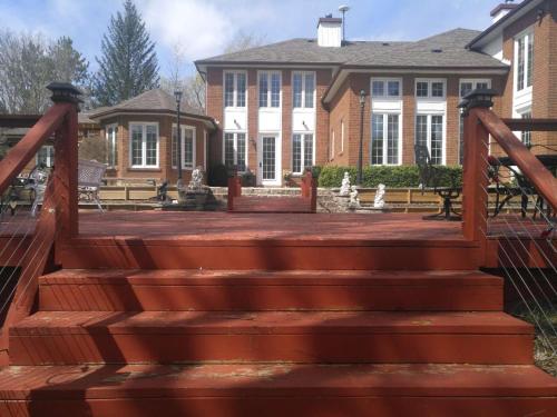 a wooden staircase in front of a house at Lakeside Private suite-Queen bed room in Tottenham