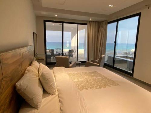 Wadi Shab/Fins Villa في Fins: غرفة نوم مع سرير وإطلالة على المحيط