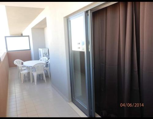 a dining room with a table and a glass door at Rocha Tower Apartments in Portimão