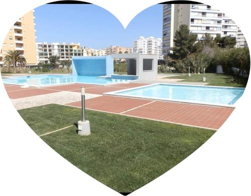 a heart shaped picture of a swimming pool with a heart at Rocha Tower Apartments in Portimão