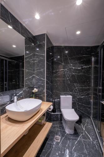 a bathroom with a white tub and a toilet at Amazing Apartments @ Monastiraki Subway Station in Athens