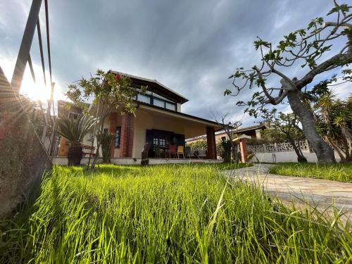 a house with tall grass in front of it at Villa Settimia a 50 mt dalla spiaggia! in Àrbatax
