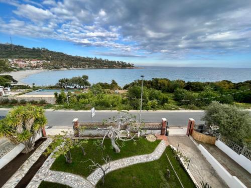 a garden with a view of the ocean at Villa Settimia a 50 mt dalla spiaggia! in Àrbatax
