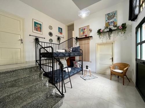 a living room with a spiral staircase in a house at Villa Settimia a 50 mt dalla spiaggia! in Àrbatax