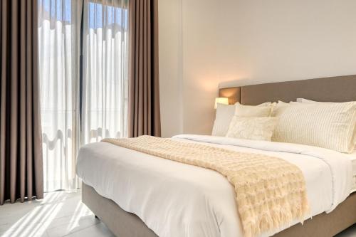 a bedroom with two beds and a large window at Beco Santa Emilia 3M, a Home in Madeira in Funchal