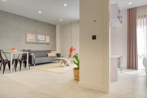 a living room with a couch and a table at Beco Santa Emilia 3M, a Home in Madeira in Funchal