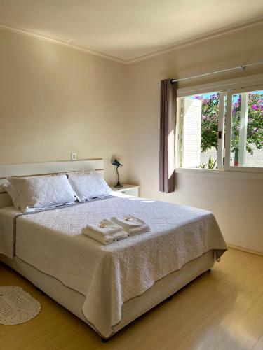 a bedroom with a bed with three towels on it at Morada da Esperança in Vespasiano Corrêa