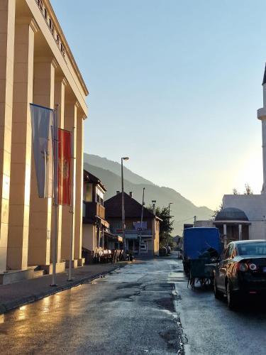 a street with cars parked on the side of a building at SARAH APARTMENTS in Gusinje