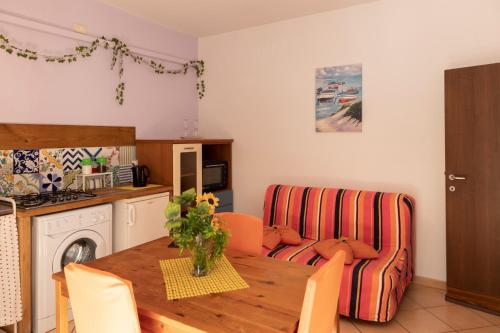a kitchen and living room with a table and a couch at PALAZZO PELLEGRINO vietri in Vietri sul Mare