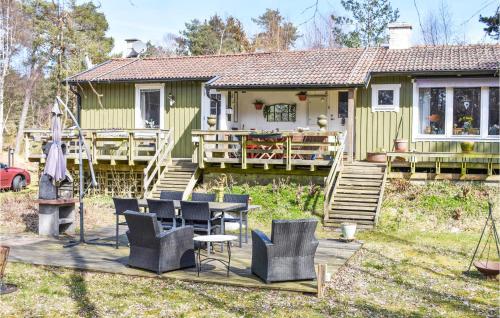 a house with a table and chairs in front of it at Stunning Home In Borrby With Wifi in Borrby