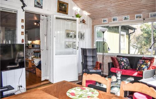 a tiny house with a living room and a dining room at Stunning Home In Borrby With Wifi in Borrby