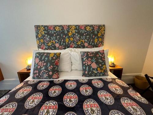 a bedroom with a large bed with colorful blankets and pillows at The Resch House in Sydney