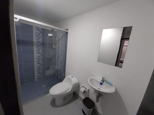 a bathroom with a toilet and a sink and a shower at Los balcones ll in Medellín