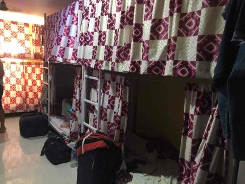a dorm room with a bunk bed and a table at Indian Drom Hostel-PG in Mumbai