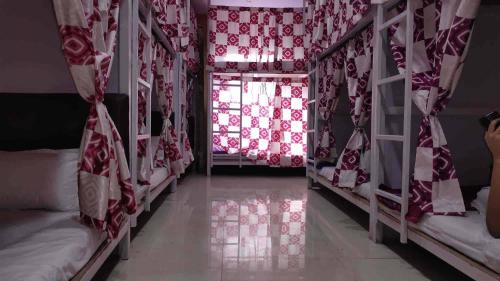 a room with a window with red and white curtains at Indian Drom Hostel-PG in Mumbai