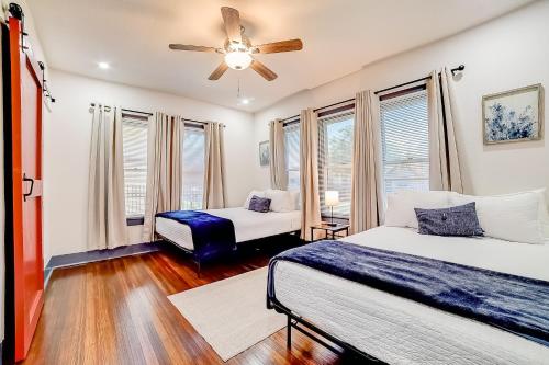 a bedroom with two beds and a ceiling fan at Lone Star Retreat in San Antonio