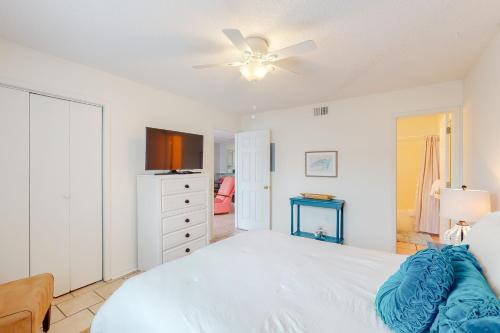 a bedroom with a white bed and a ceiling fan at Bayview 15 in Orange Beach
