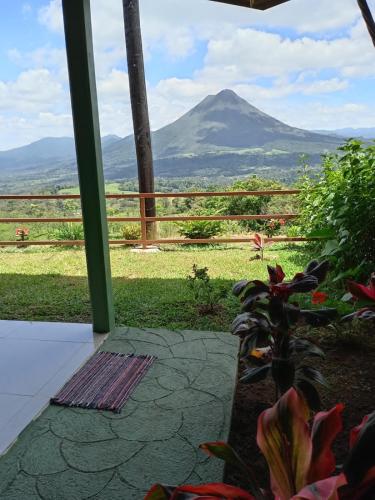 a view of a mountain from the porch of a house at Encanto Arenal lodge in Fortuna