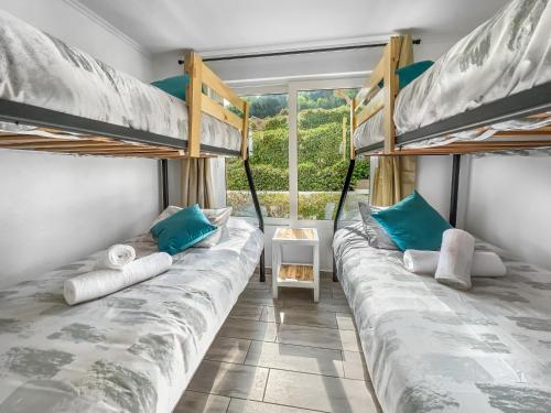 two bunk beds in a room with a window at *1era Línea 1er Piso* Jardín, Playa, Piscinas 6p in Puerto Velero