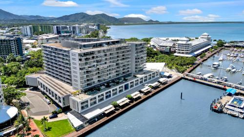 an aerial view of a large building next to the water at City Living at Harbour Lights in Cairns
