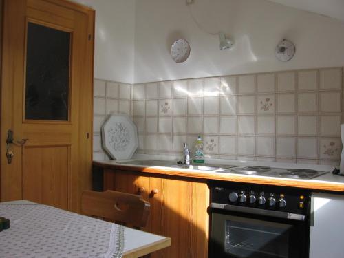 a kitchen with a stove and a sink at Zugspitzhome Appartment in Farchant