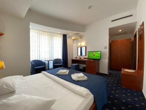 a hotel room with a bed and a television at Samaa Hotel in Bucharest
