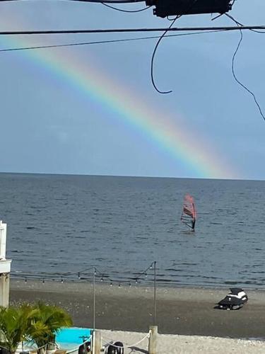 a kite flying over the ocean on a beach at A little place in the Sun in Milford