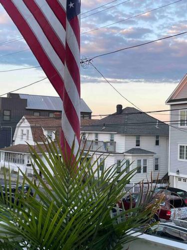 an american flag flying in front of a house at A little place in the Sun in Milford