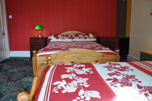 A bed or beds in a room at Bryncoed Guest House 