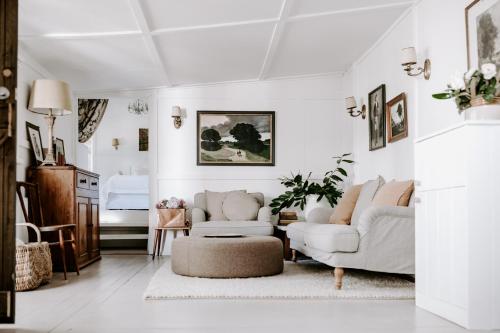 a living room with two couches and a rug at Jacks Garden Cottage at Poets Lodge in Daylesford