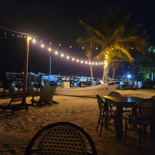 a table and chairs on a beach at night at Ocean View PLAYA DEL NIÑO Rooms & Apartments in Cancún