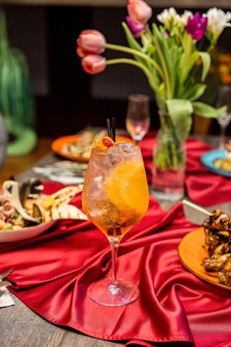 a table with a red table cloth with a drink on it at Samaa Hotel in Bucharest