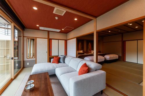 a living room with a couch and a table at Tachibana Shikitei in Kaga