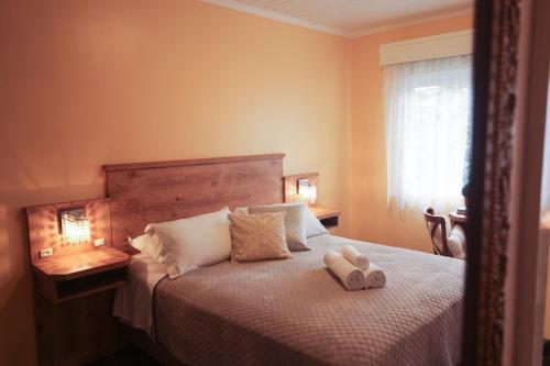 a bedroom with a bed with two stuffed animals on it at Pousada Betânia in Gramado