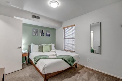 a bedroom with a large bed with a mirror at Chic Poolside Oasis - Karaoke - BBQ - Games in Phoenix