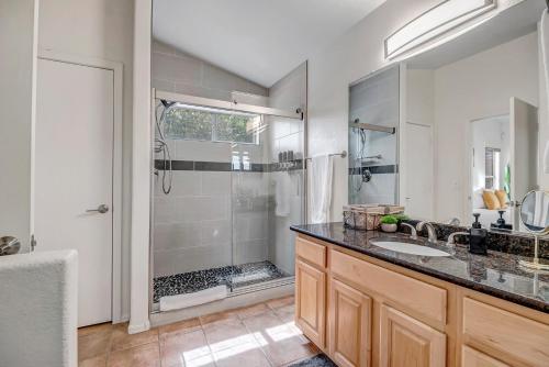a bathroom with a shower and a sink at Chic Poolside Oasis - Karaoke - BBQ - Games in Phoenix