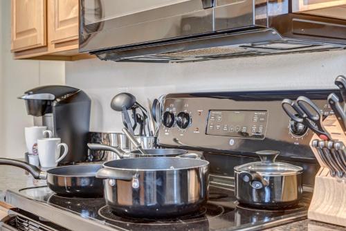 a kitchen with pots and pans on a stove at Chic Poolside Oasis - Karaoke - BBQ - Games in Phoenix