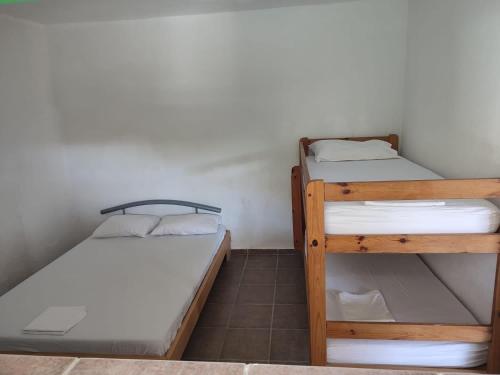 a room with two bunk beds in a room at Secluded fisherman's cottage Cove Lupescina, Kornati - 18657 in Murter