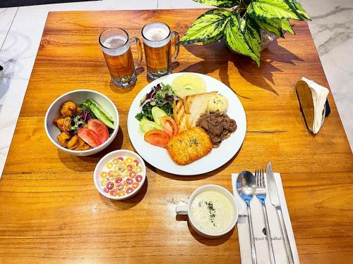 a wooden table topped with plates of food and drinks at Le Stendal Hotel in Daejeon