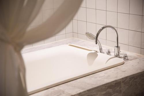 a bathroom sink with a faucet on a counter at Le Stendal Hotel in Daejeon