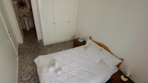 a bedroom with a white bed in a room at zina surf house in Oualidia
