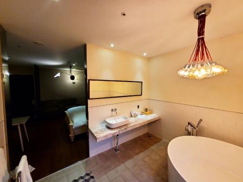 a bathroom with a sink and a mirror at Le Stendal Hotel in Daejeon