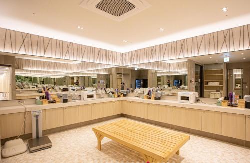 a large kitchen with a bench in the middle at C-One Resort Jaeundo in Sinan