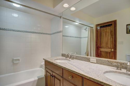 a bathroom with two sinks and a tub and a mirror at St. James Place in Beaver Creek