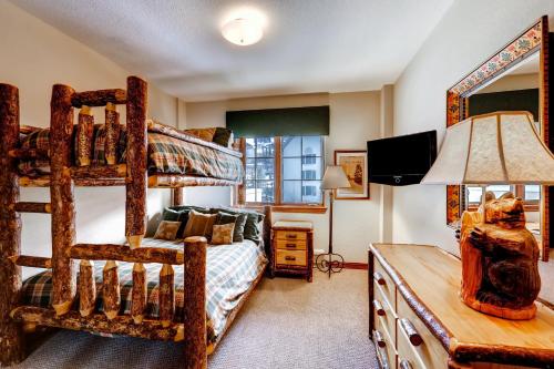 a bedroom with a bunk bed and a desk with a lamp at St. James Place in Beaver Creek