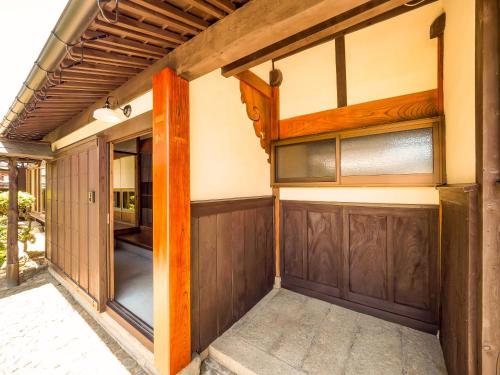 a garage with a wooden garage door at Chikubu Yuuan in Nagahama