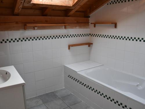 a bathroom with a tub and a sink at Chalet Pralognan-la-Vanoise, 5 pièces, 8 personnes - FR-1-464-176 in Pralognan-la-Vanoise