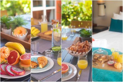 a table topped with plates of food and orange juice at Villa Maorie 5 chambres avec piscine privée in Le François