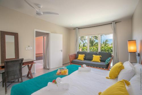a living room with a bed and a couch at Villa Maorie 5 chambres avec piscine privée in Le François