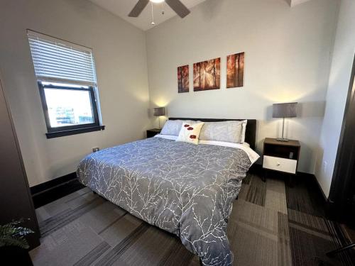 a bedroom with a bed and a window at Trendy Downtown Apartments in Roanoke